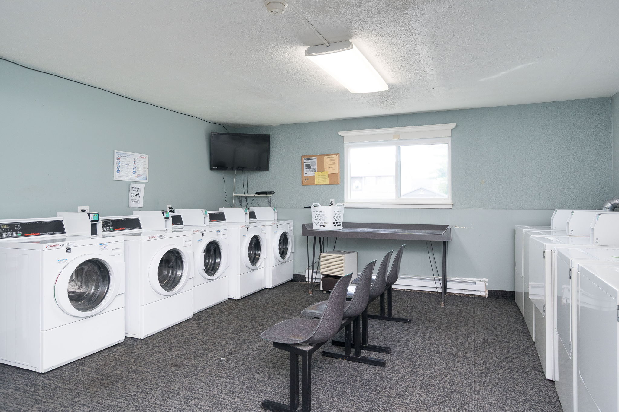 A laundry room with washers and dryers.
